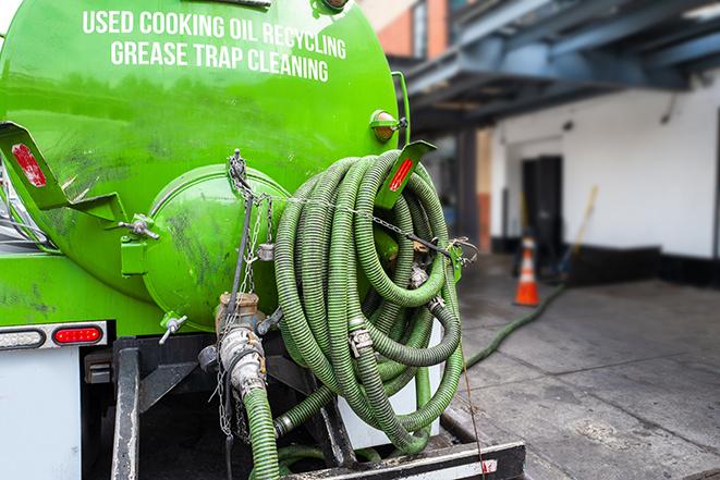 a vacuum truck pumping out a large underground grease trap in Anderson